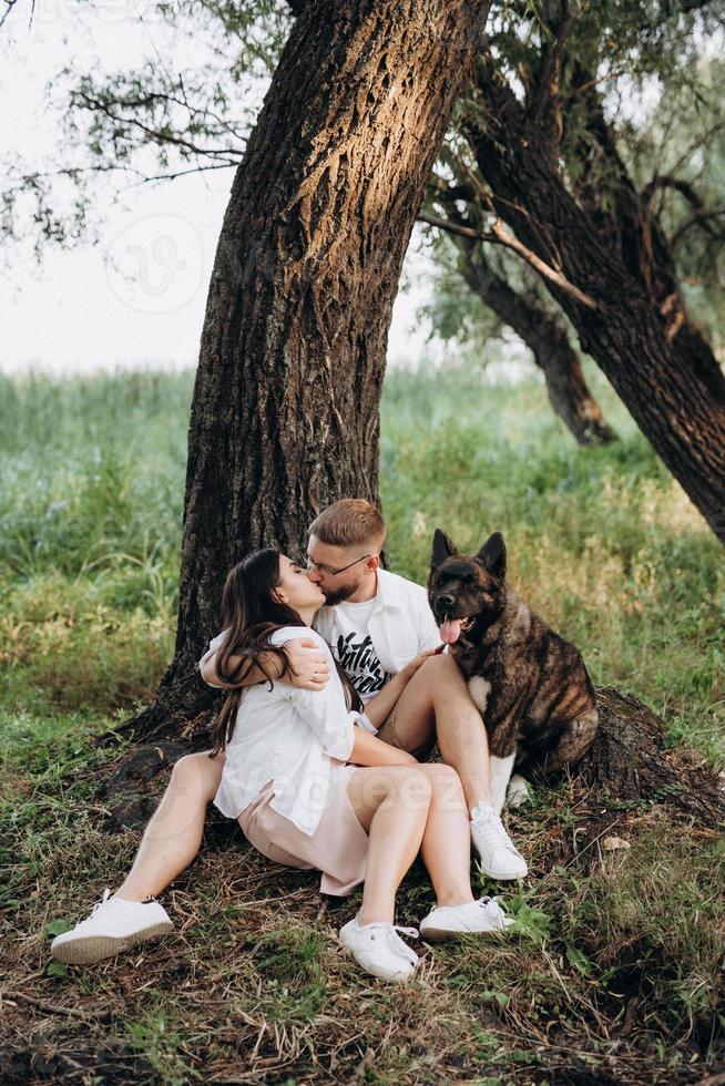 Big dog for a walk with a guy and a girl photo