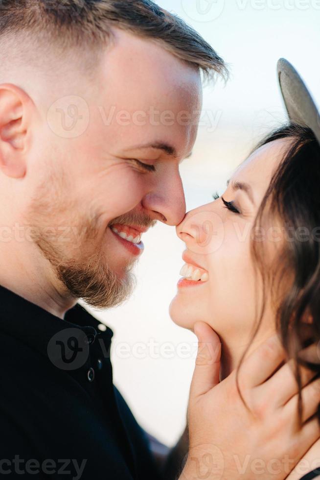 young couple a guy and a girl with joyful emotions in black clothes walk through the white desert photo