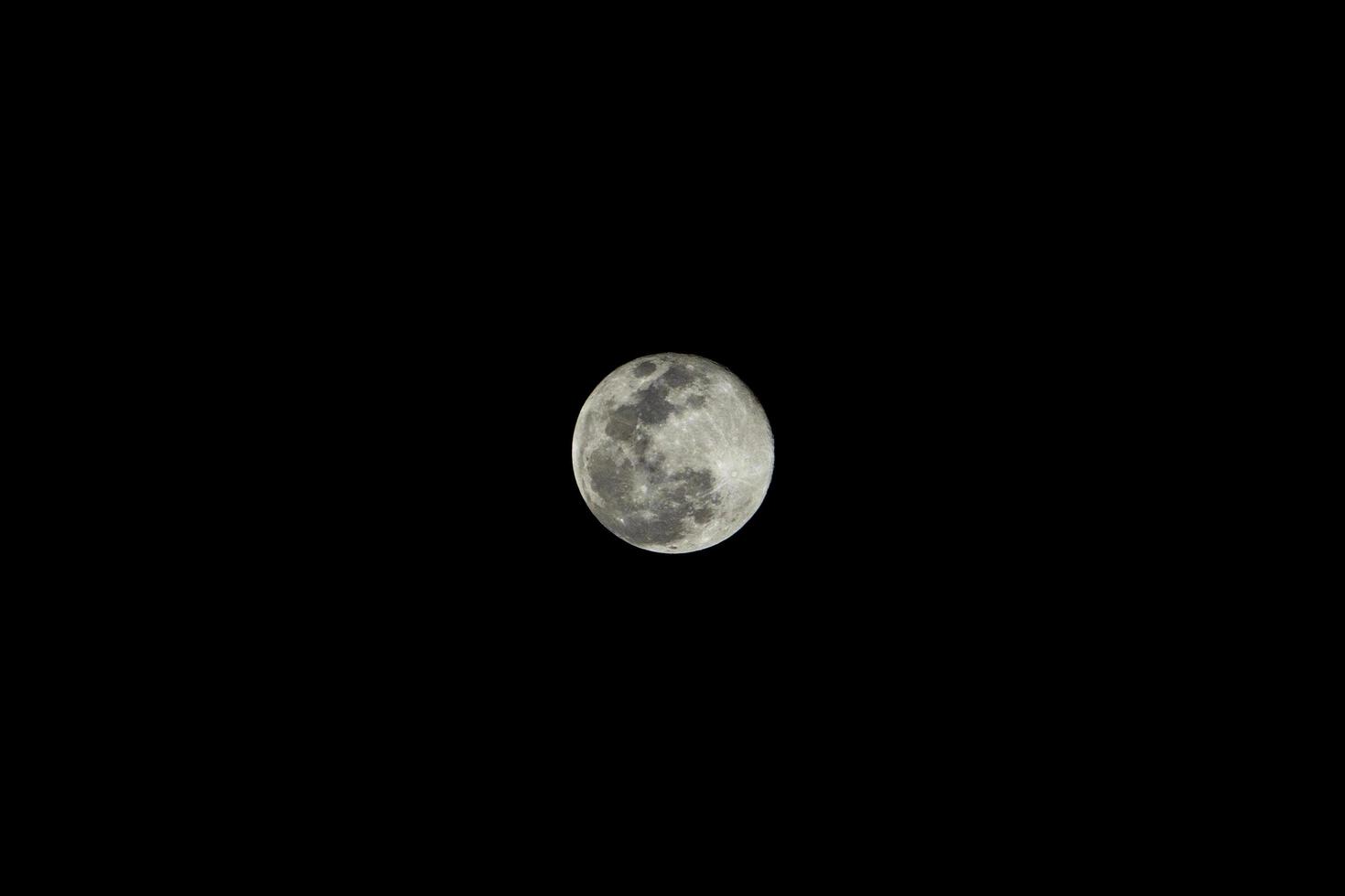 Close up of super moon isolated on black night background photo