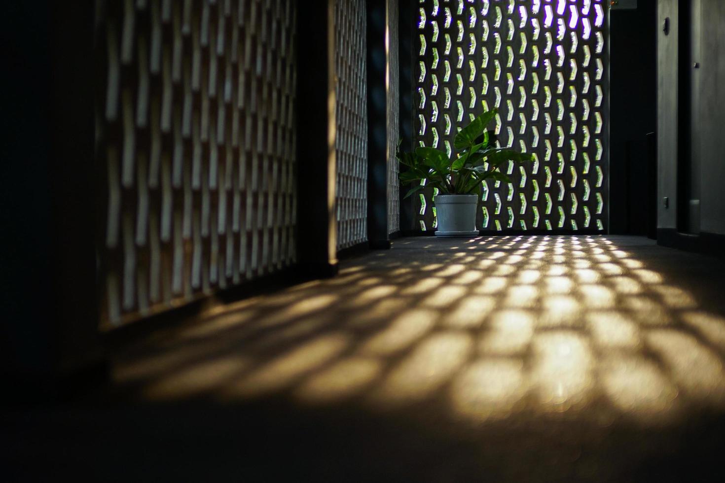 Selective focus on the cement floor of corridor reflecting light of sunset with blurred bokeh lights background. photo