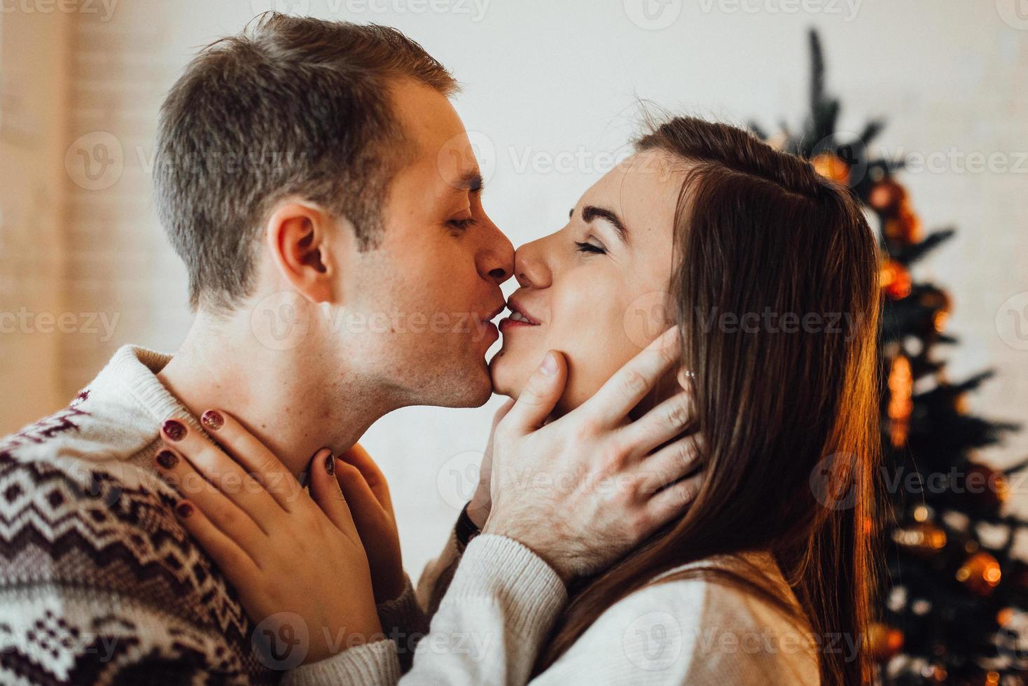 guy and a girl celebrate the new year together and give each other gifts photo