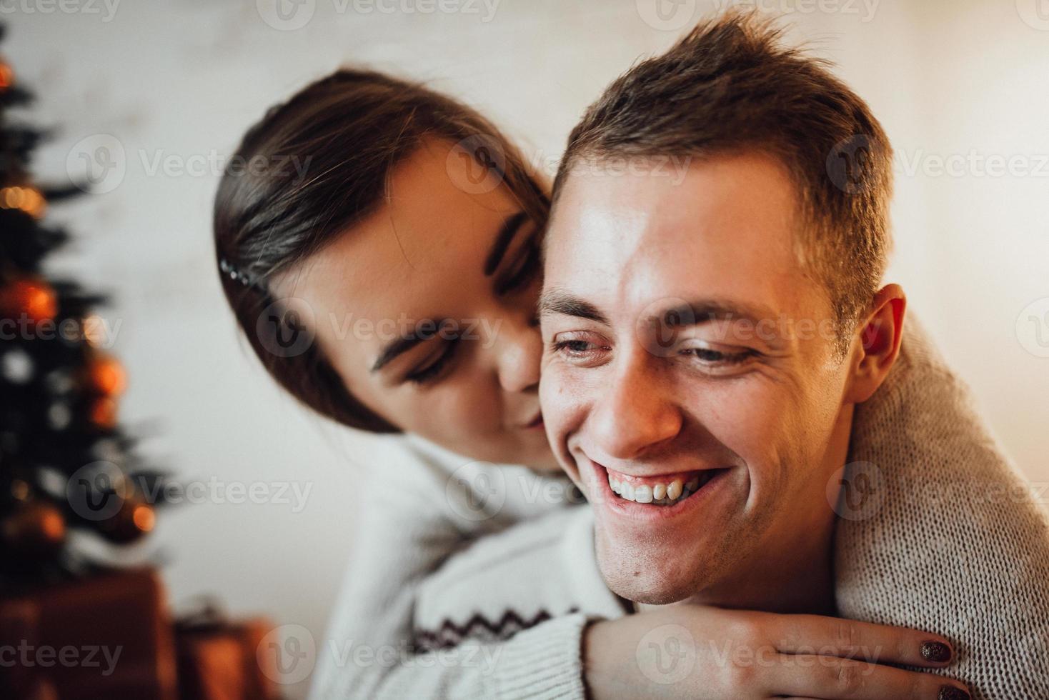 guy and a girl celebrate the new year together and give each other gifts photo