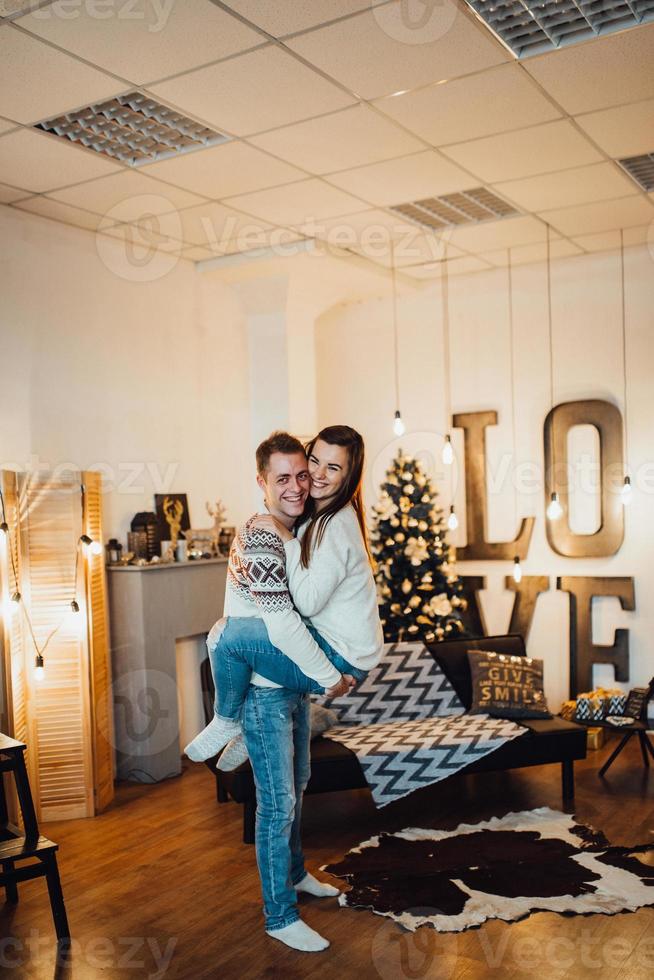 guy and a girl celebrate the new year together and give each other gifts photo