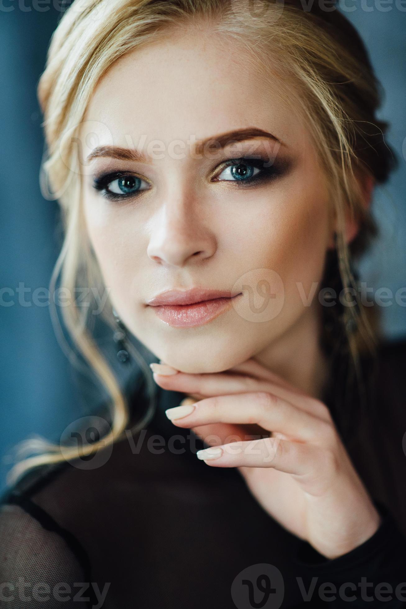 Blonde girl with blue eyes in a black dress 2377091 Stock Photo at Vecteezy
