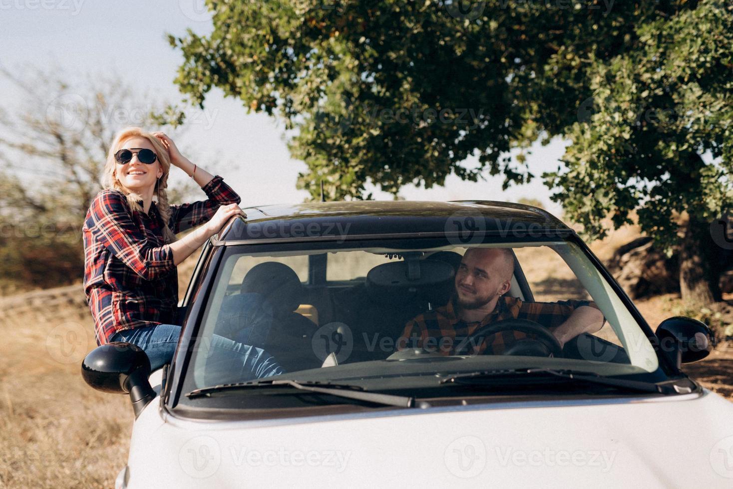 traveling by car of a young couple of a guy and a girl photo