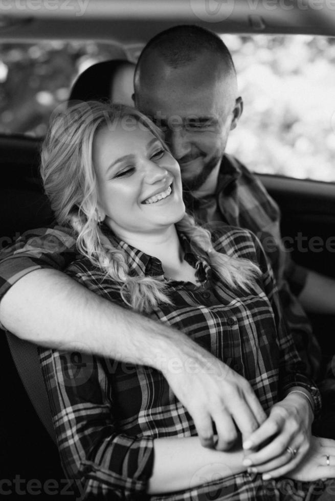 traveling by car of a young couple of a guy and a girl photo