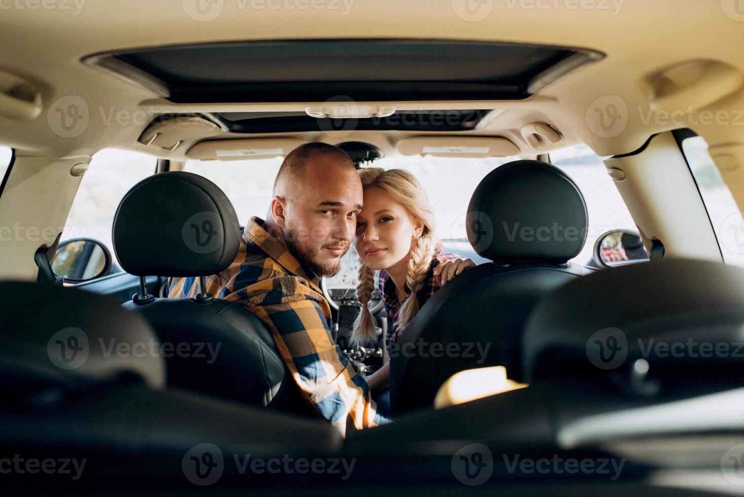 traveling by car of a young couple of a guy and a girl photo