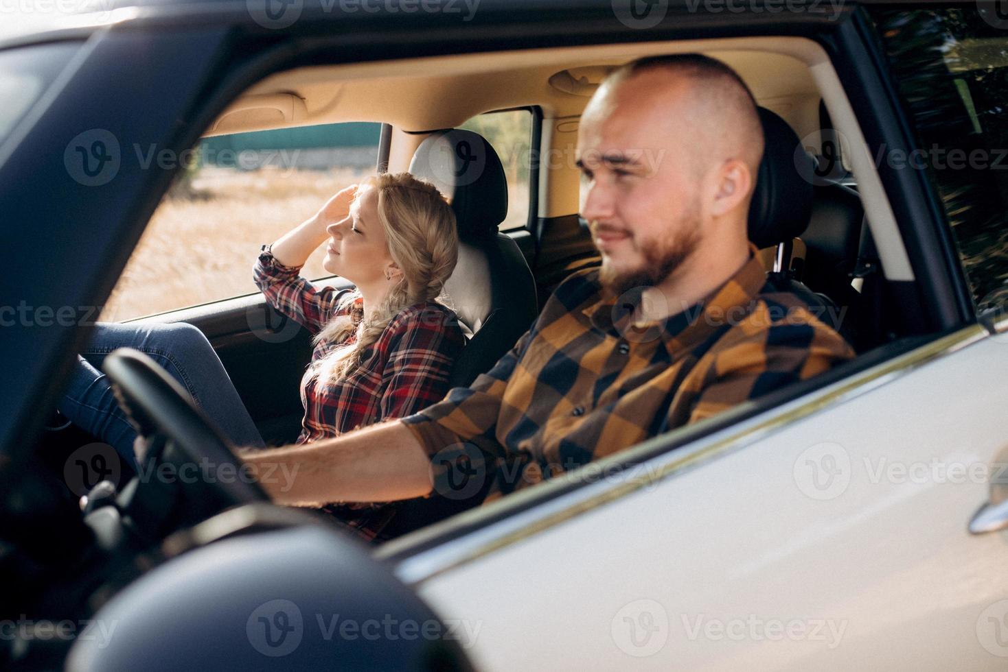 traveling by car of a young couple of a guy and a girl photo