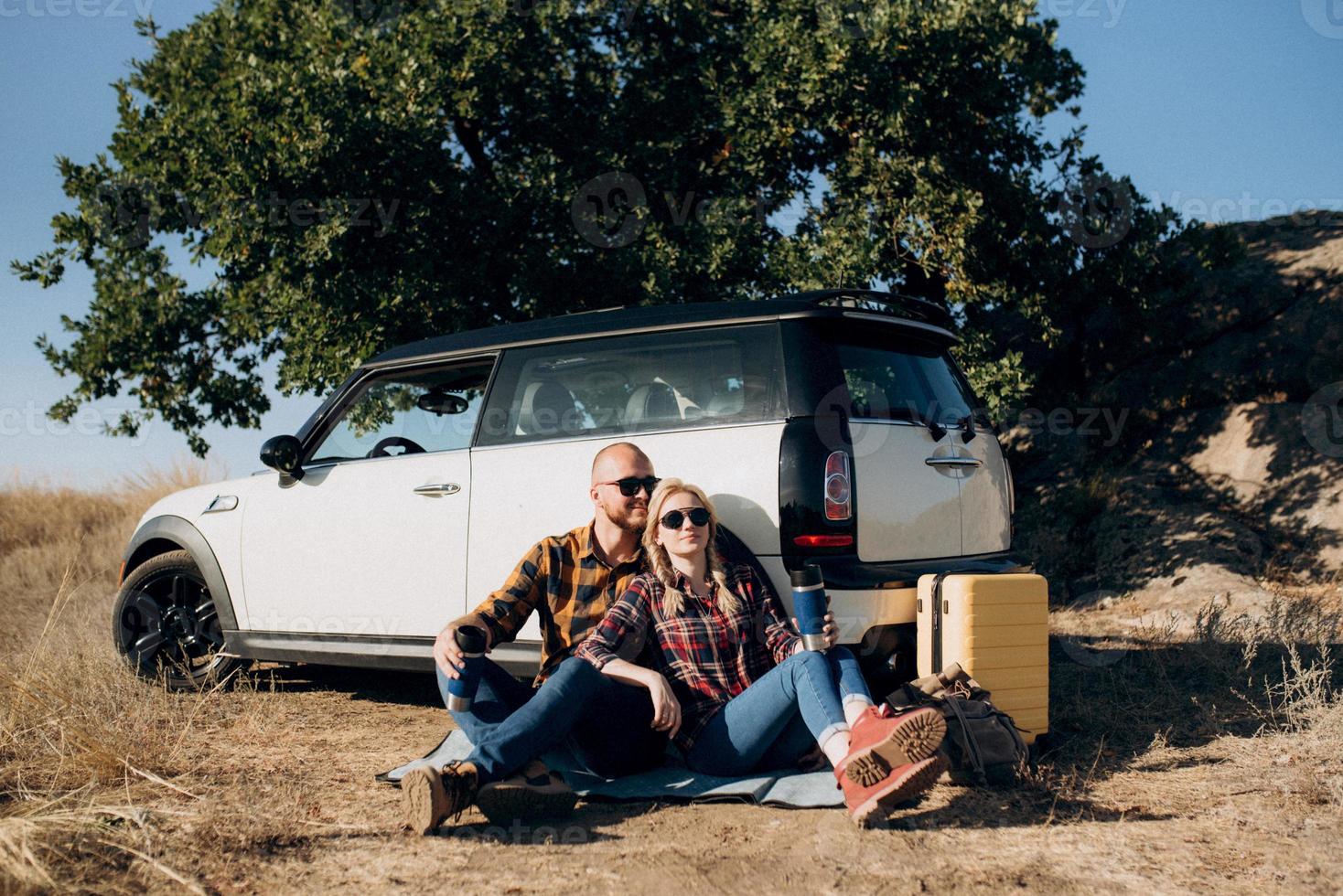 traveling by car of a young couple of a guy and a girl photo