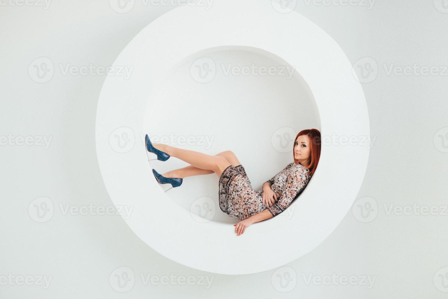 red haired model girl on a white circle background photo