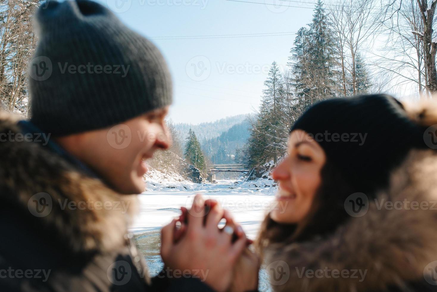 boy and girl outdoors on a winter walk playing snowballs photo