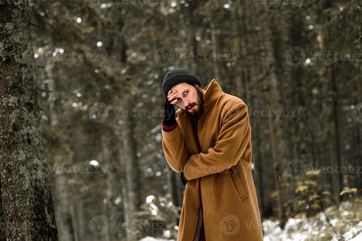 man in the winter forest photo