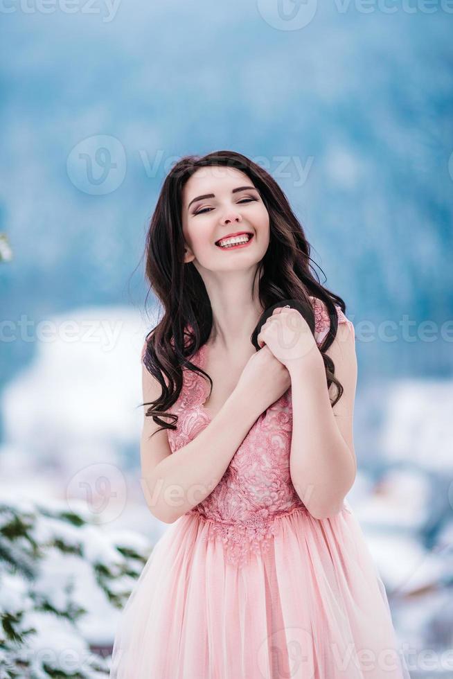 Novia con cabello castaño fondo azul de las montañas de invierno foto