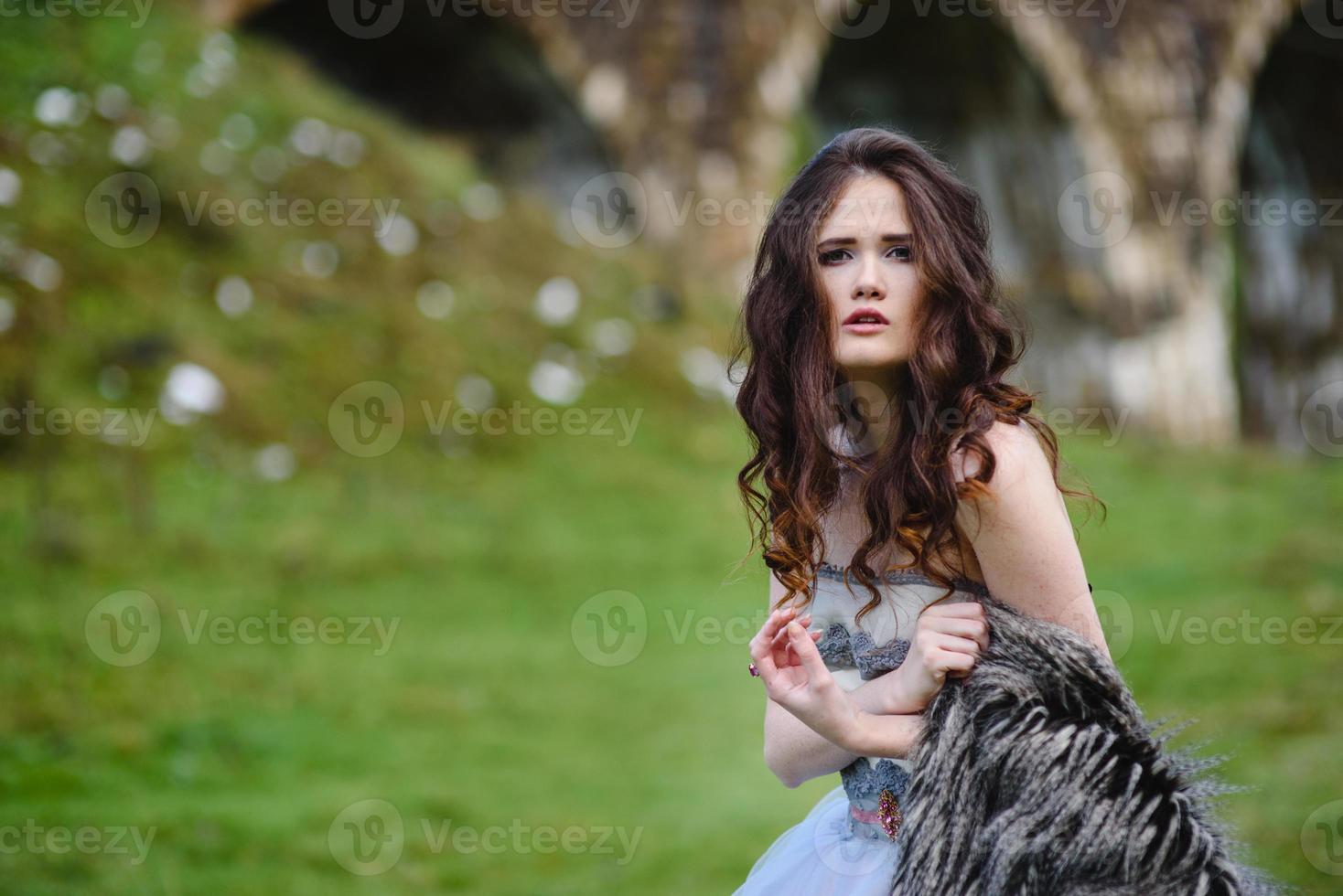 bride walks under a bridge photo