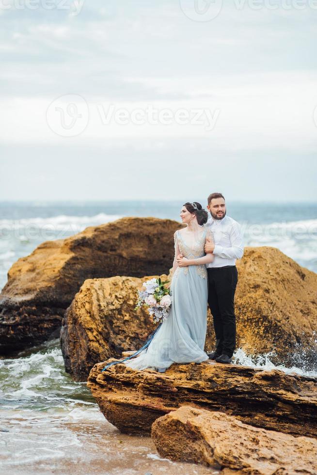 same couple with a bride in a blue dress walk photo