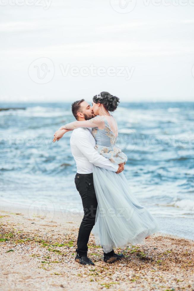 same couple with a bride in a blue dress walk photo