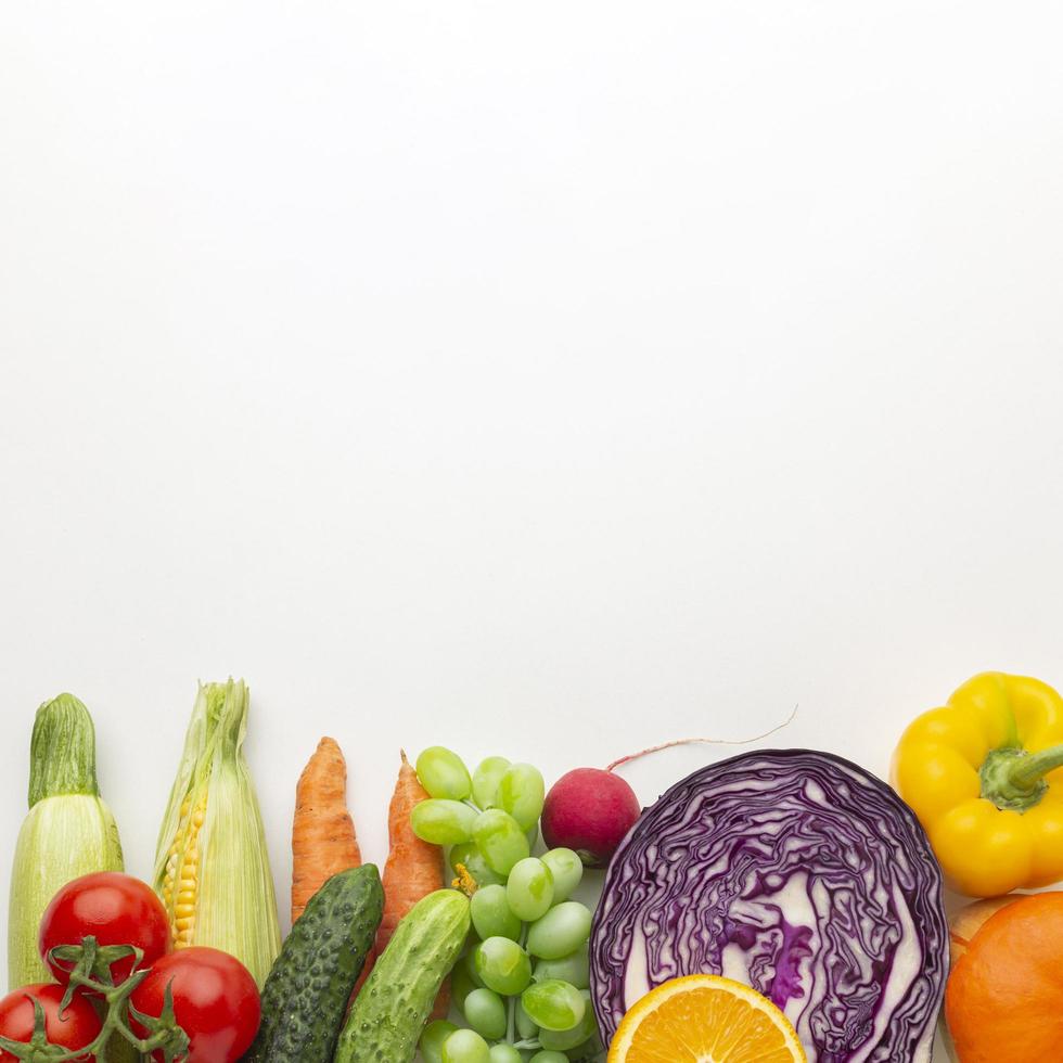 Vegetables and fruits at bottom of the frame photo