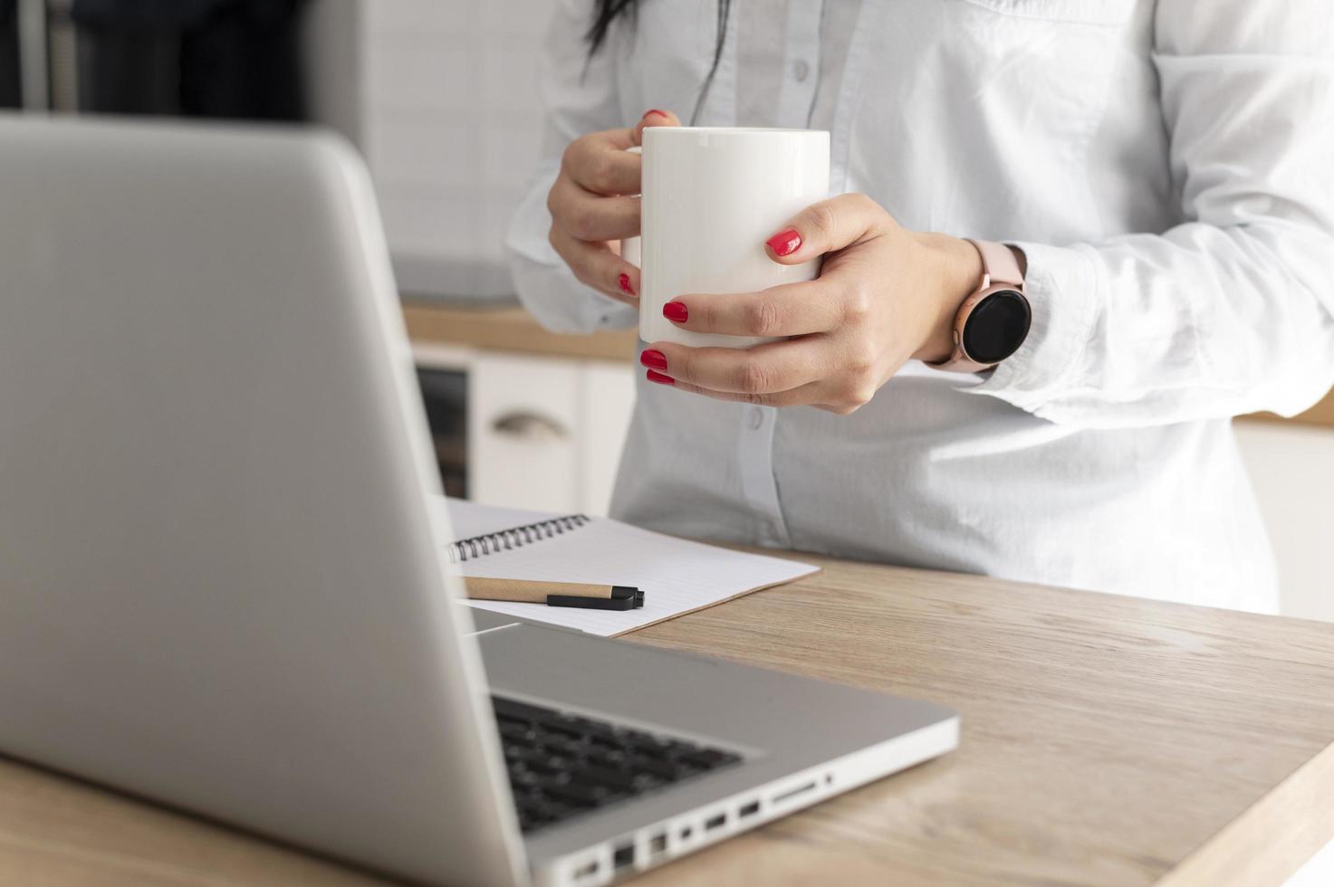 Person drinking coffee at desk photo