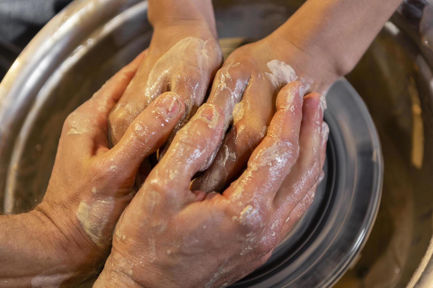 Two people making pottery photo