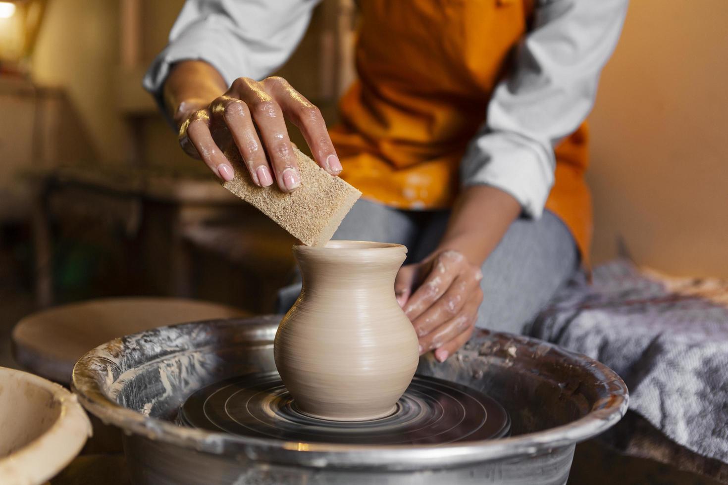 Person making pottery photo