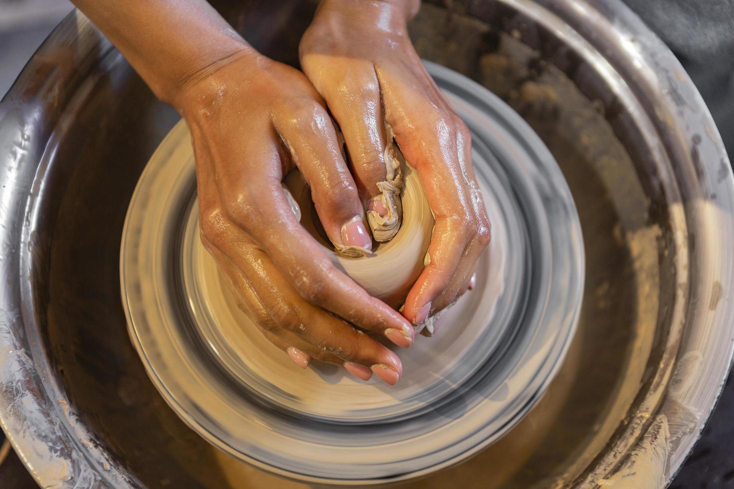 Hands shaping pottery photo