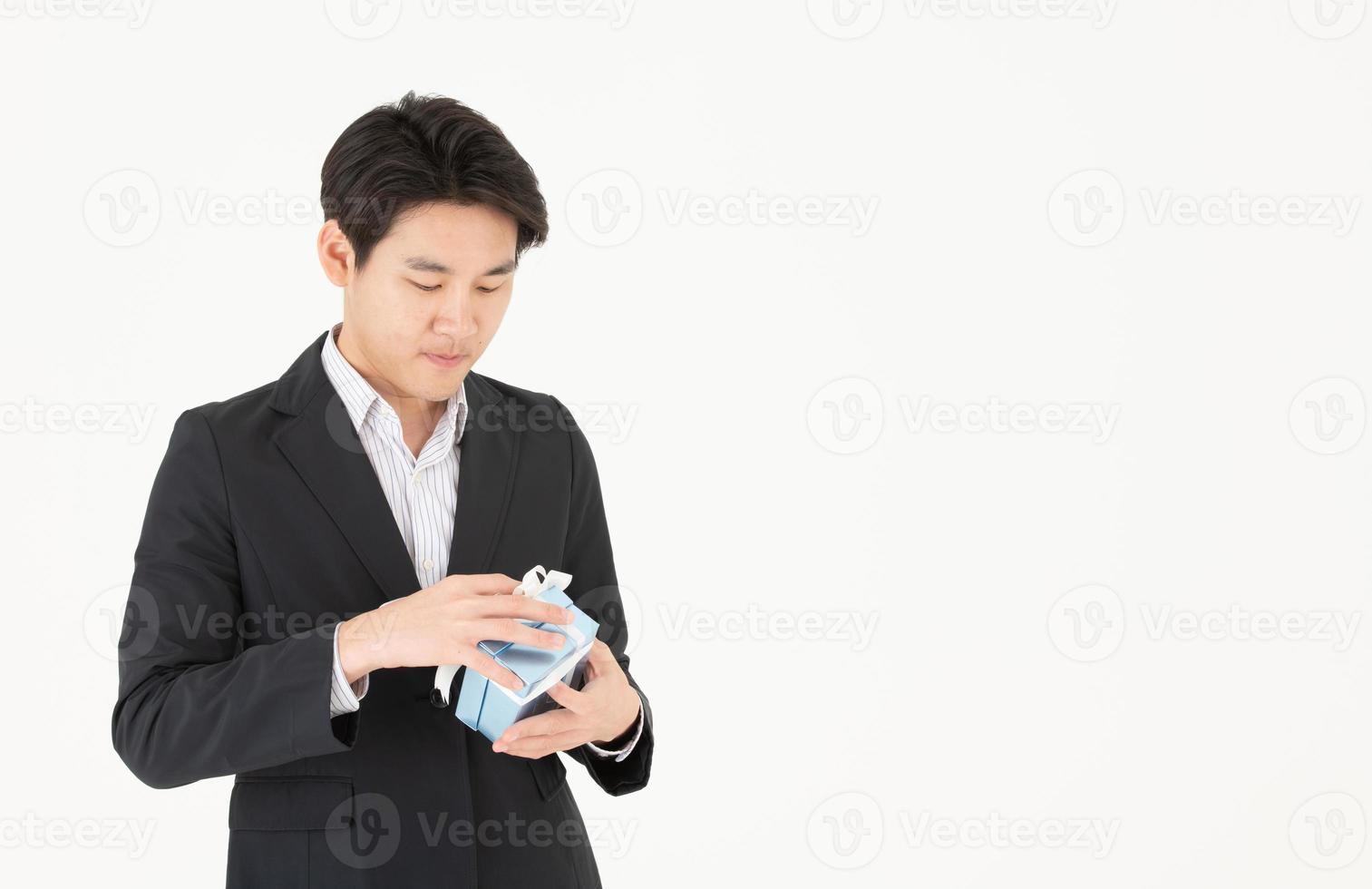 Asian businessman and expressions when opening gift boxes photo