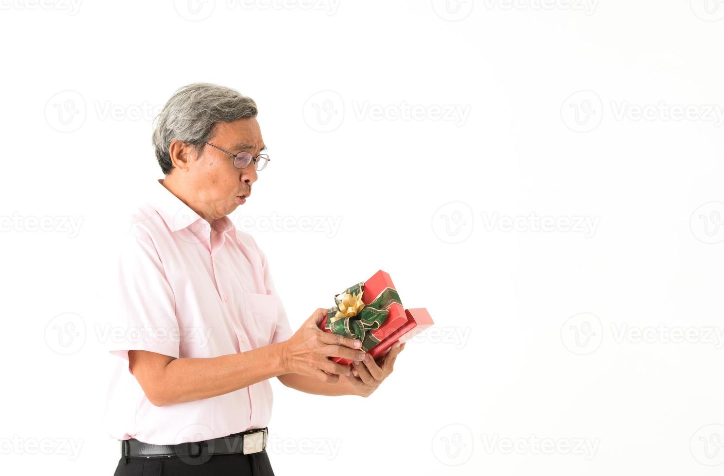 Senior hombre asiático con caja de regalo, aislado foto