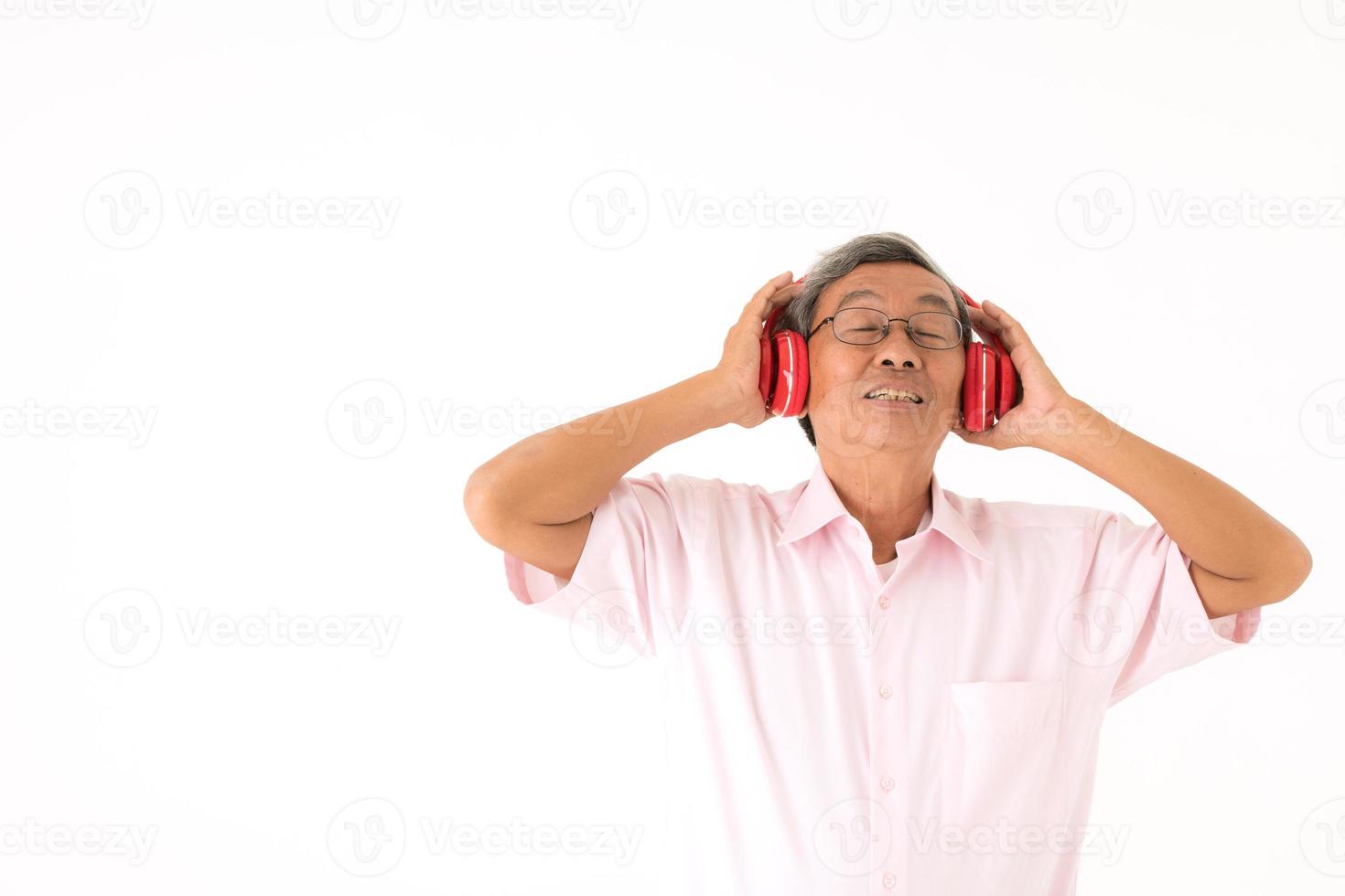 Senior Asian man happy to listen to music online, isolated photo