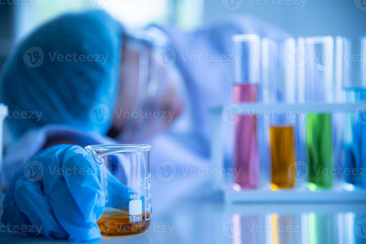 Asian young women scientist lab testing and analysis chemical at the laboratory photo