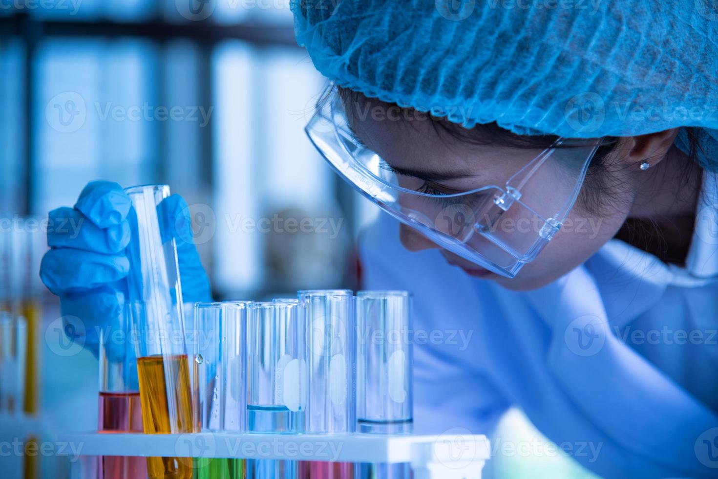 Asian young women scientist lab testing and analysis chemical at the laboratory photo