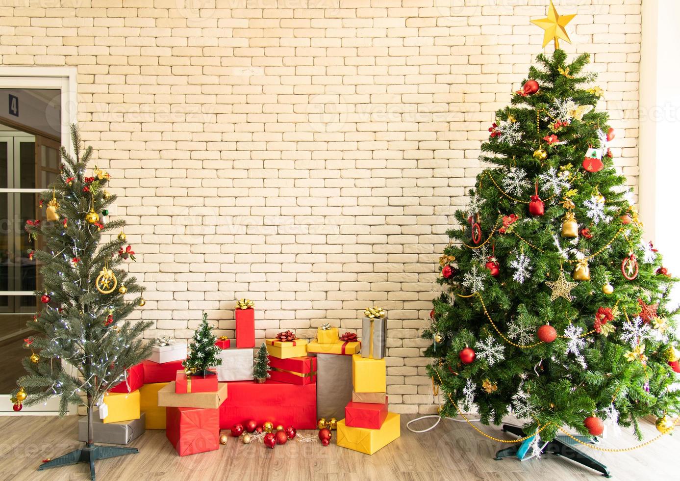 Christmas tree decorated in the living room to prepare for the new year. Decorate the living room and christmas tree with a box of red balls, golden balls, golden bells, snow stars, socks. photo