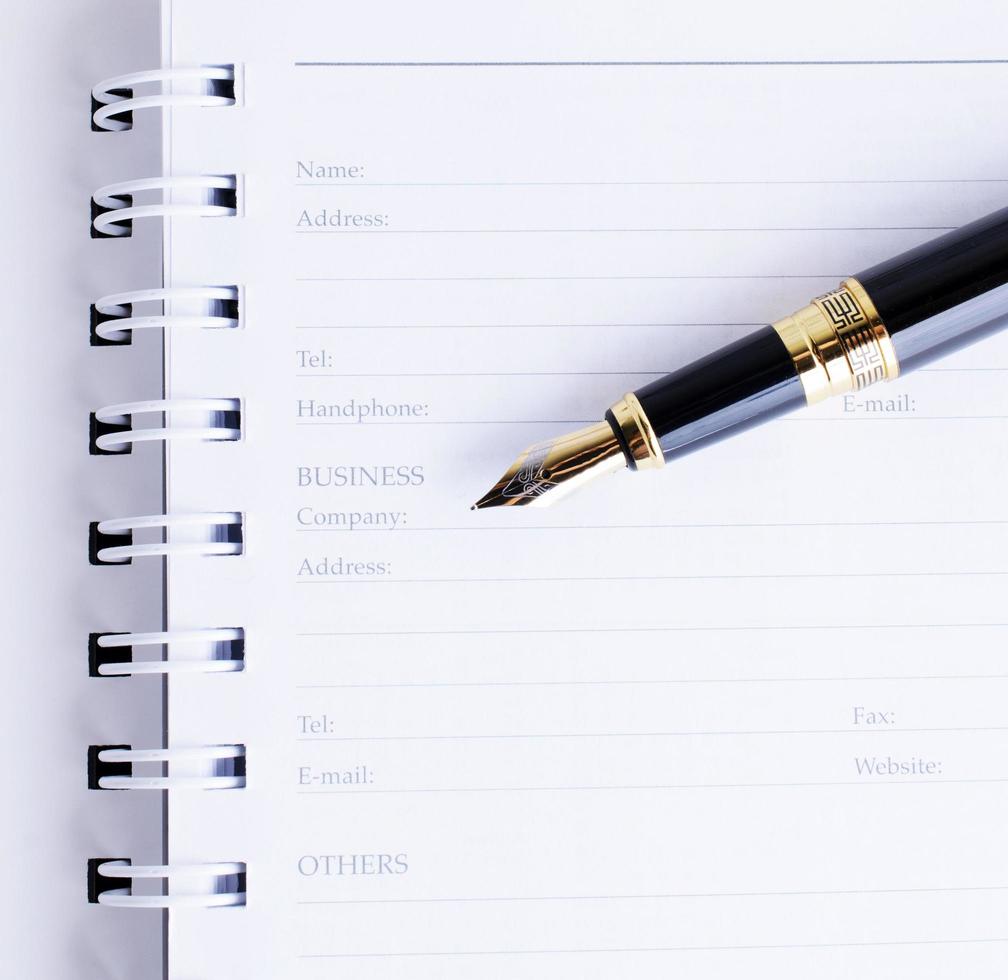 Close up of Fountain pen on Business memory book page photo