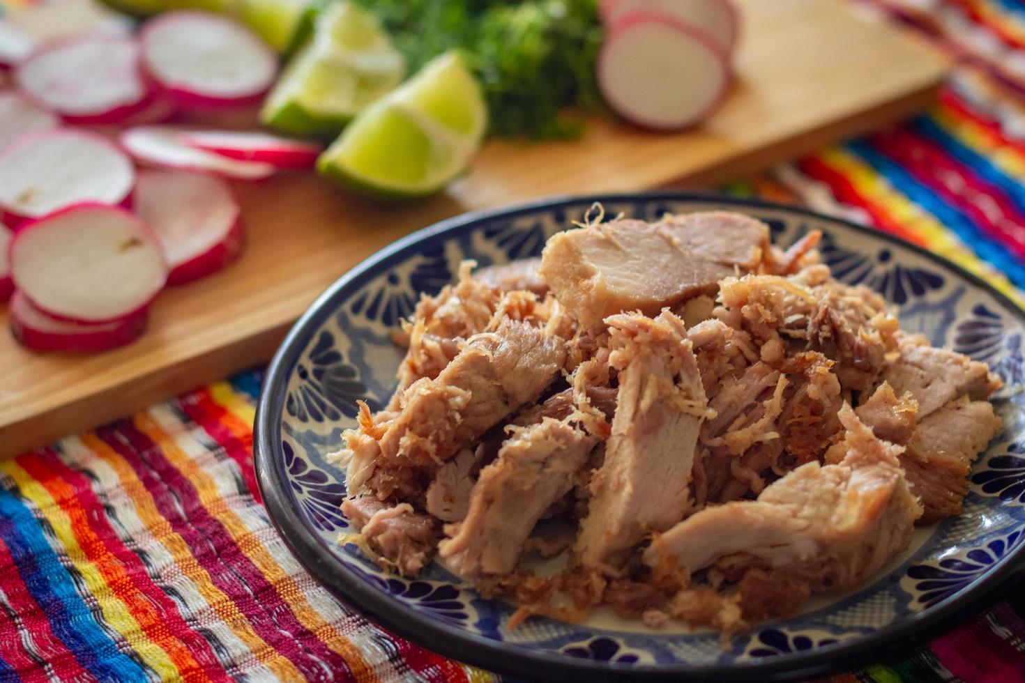 Dish of poblano carnitas on a talavera plate and Mexican background photo