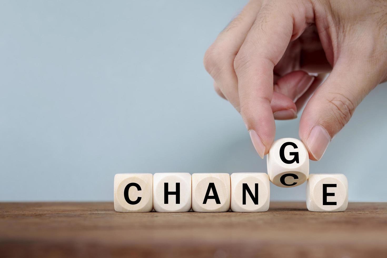 Hand Changing word from CHANCE  to CHANGE On Wooden Cube photo