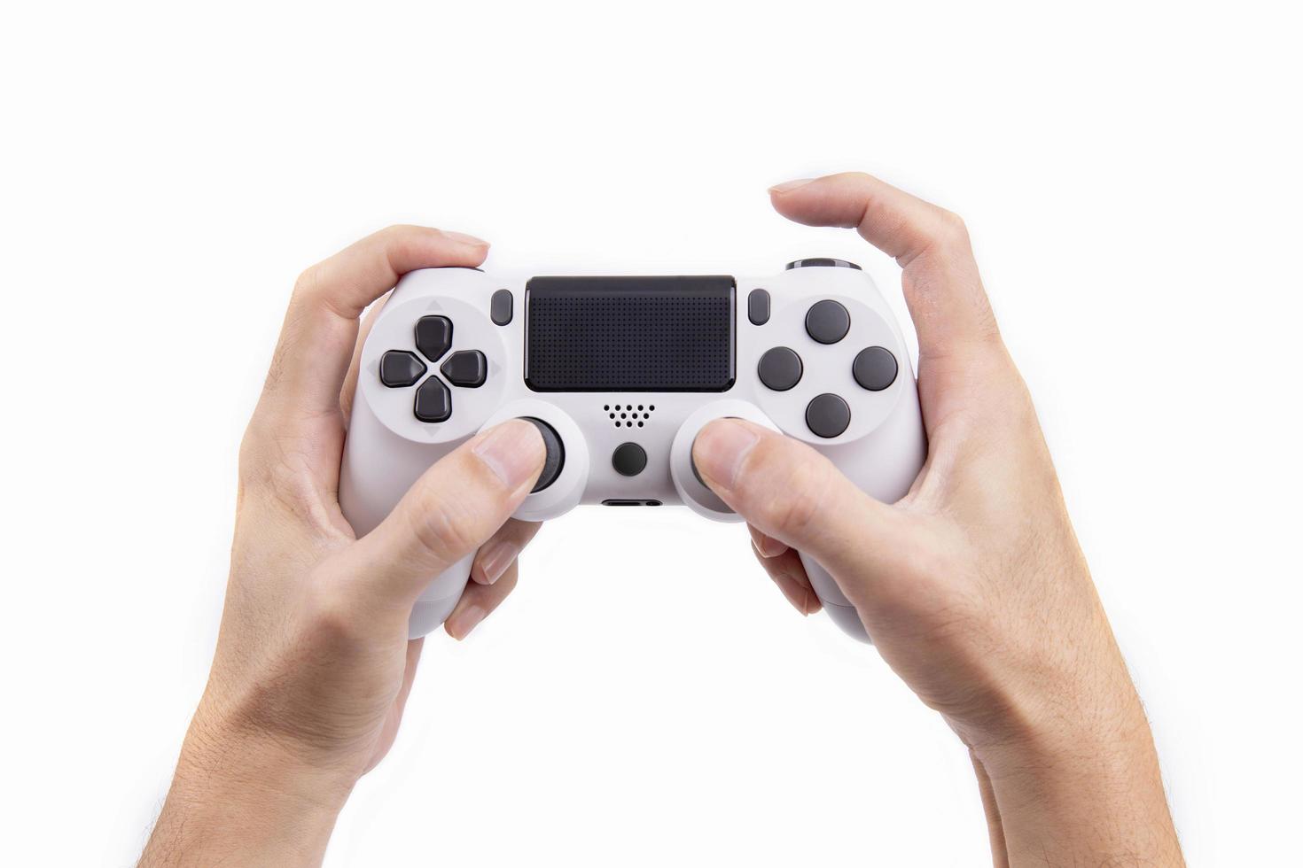 Joystick gaming controller in hand isolated on white background , Video game console developed Interactive Entertainment photo