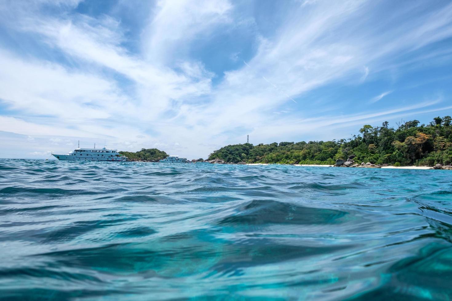 Beautiful blue wave ripple with ferry in sea photo