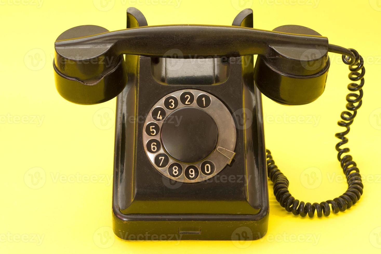 Vintage landline telephone with coiled cable photo