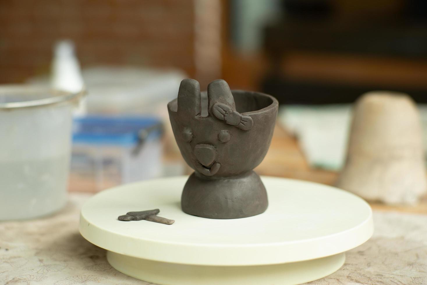 Closeup clay work of a rabbit face with a ribbon on the ear photo