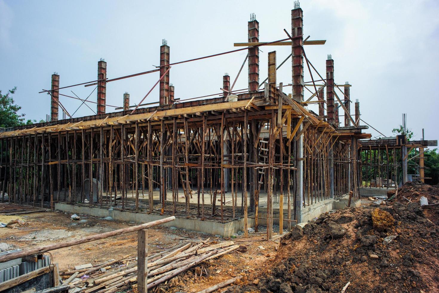 A house structure under construction at a site with a blue sky background photo