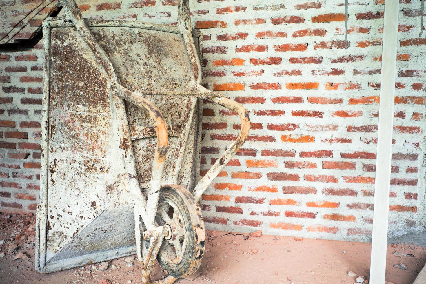 Closeup carrying cart parked at the construction site with red bricklayers wall background photo