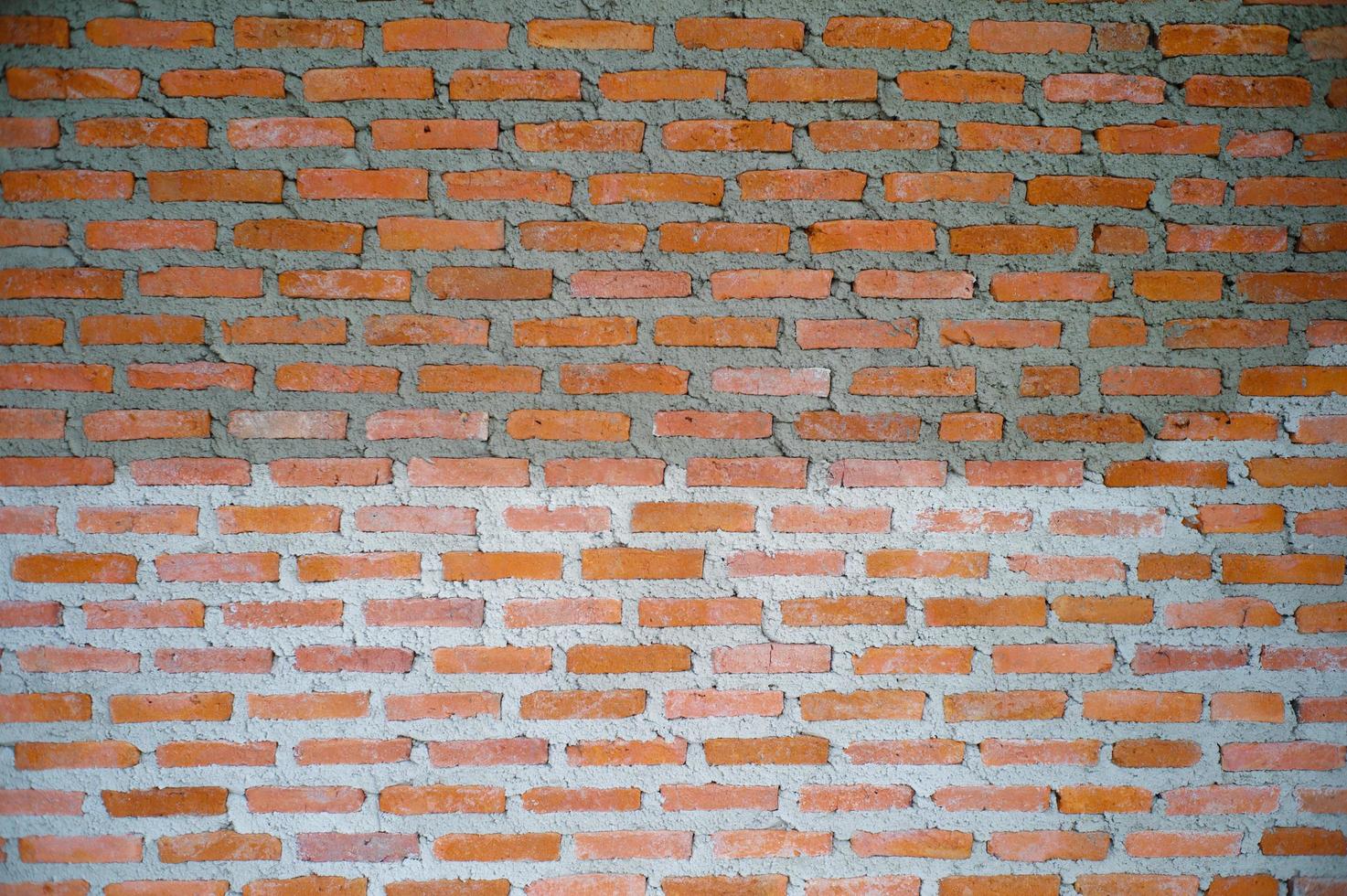 Textura abstracta y fondo de pared de albañiles rojos en el sitio de construcción foto