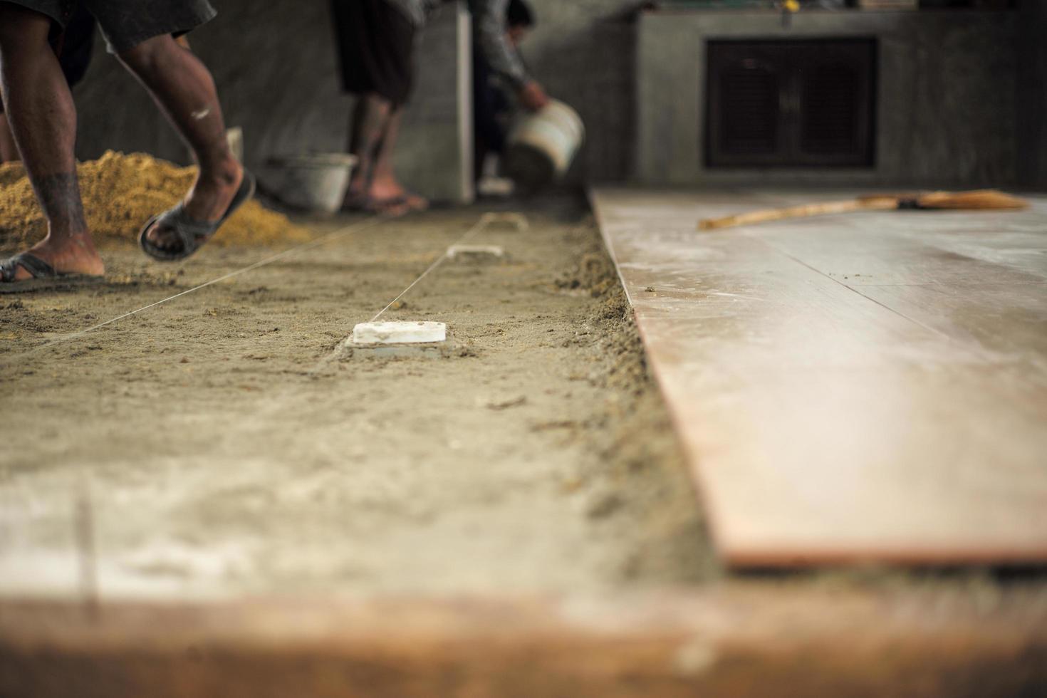 Spot focus on the floor at the construction site during installation of floor tiles photo