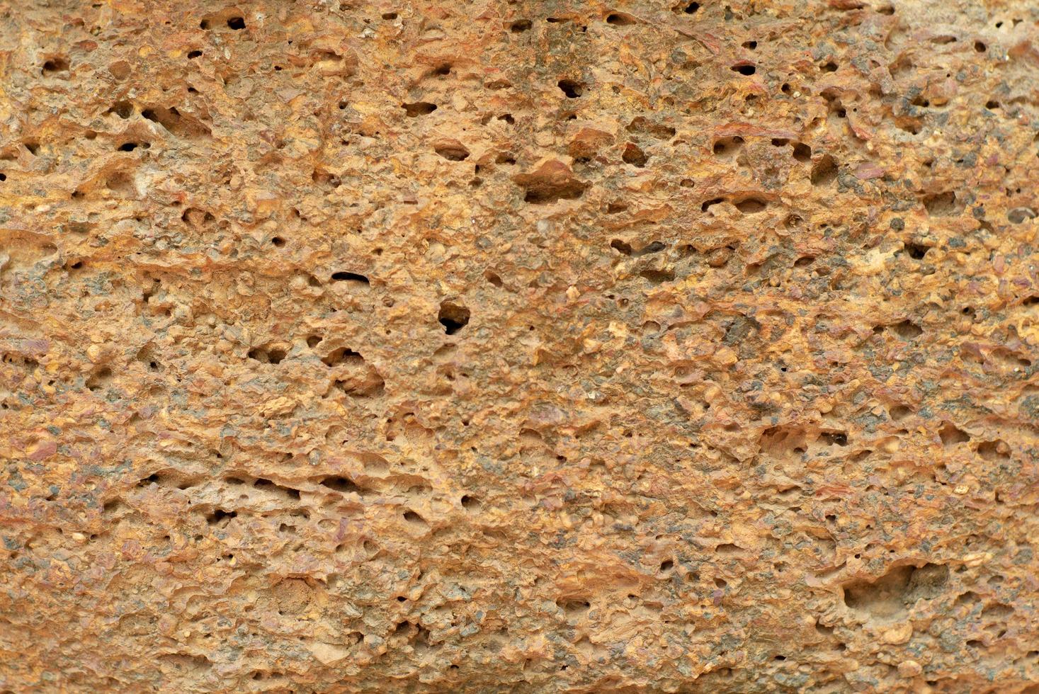 Abstract texture and background of weathered laterite wall of ancient place and temple photo