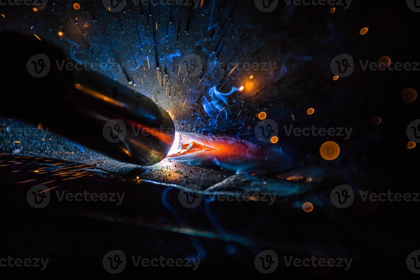 Welder, or craftsman, erecting technical industrial steel in factory photo