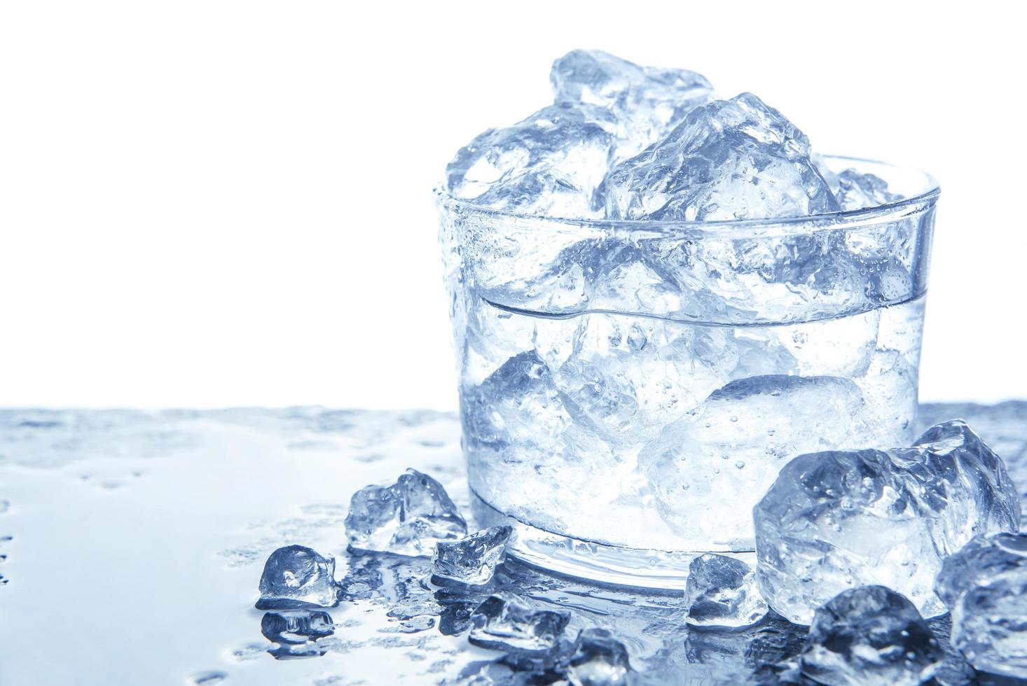 Water with ice cubes in glass photo