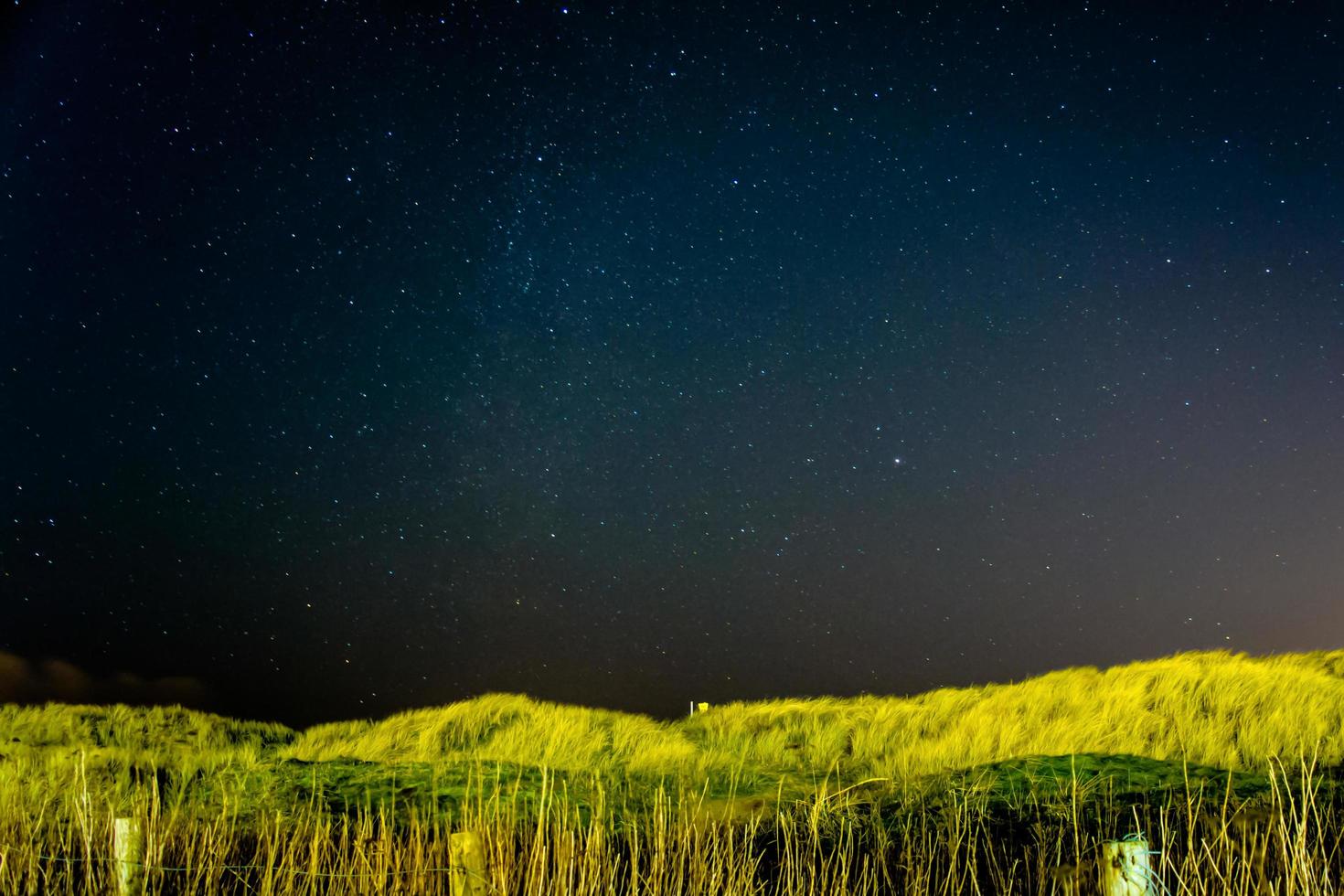 Starry sky with field illuminated photo