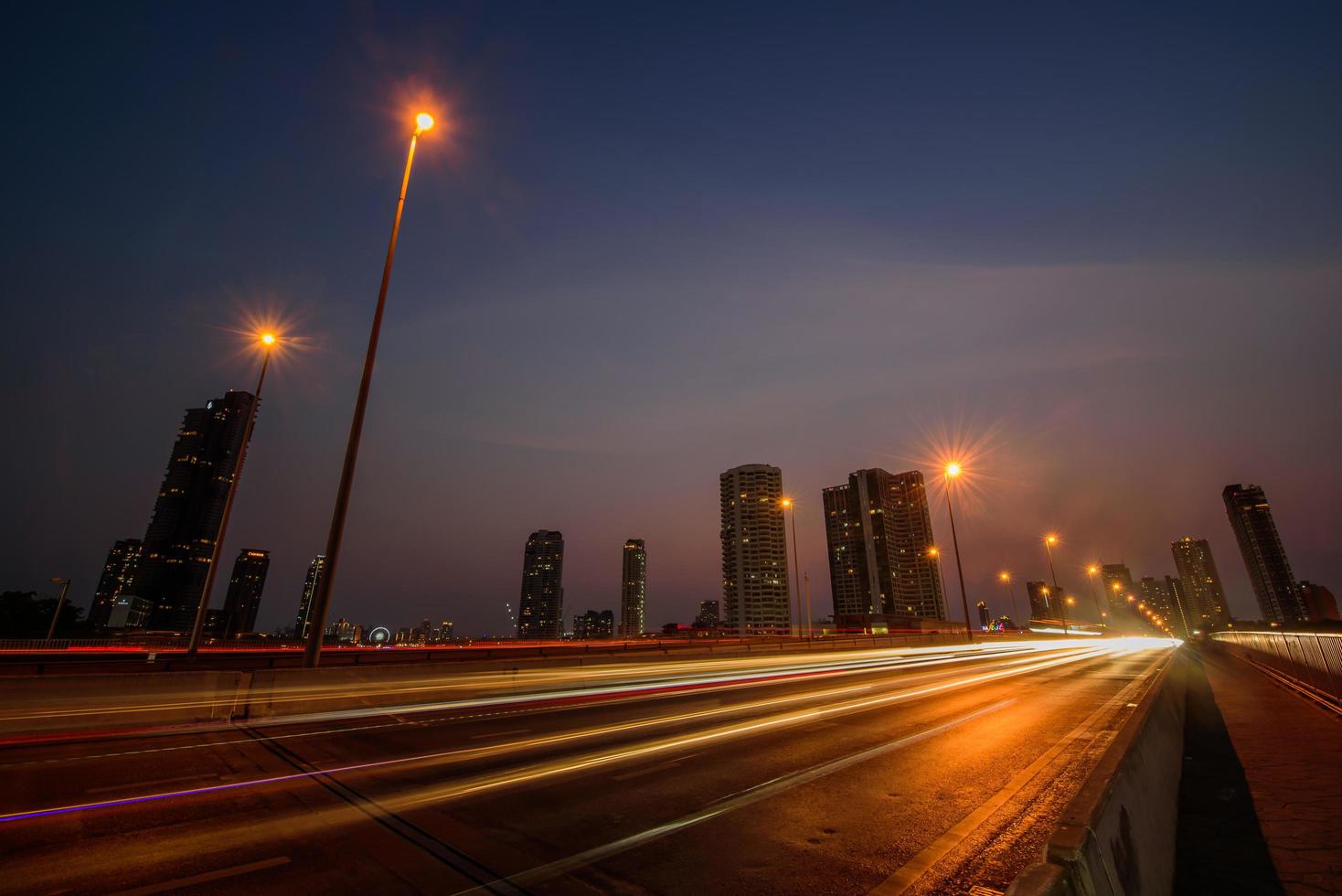 Blur lights of cars moving at road in the night time. Long exposure shutter speed of car moving in road photo