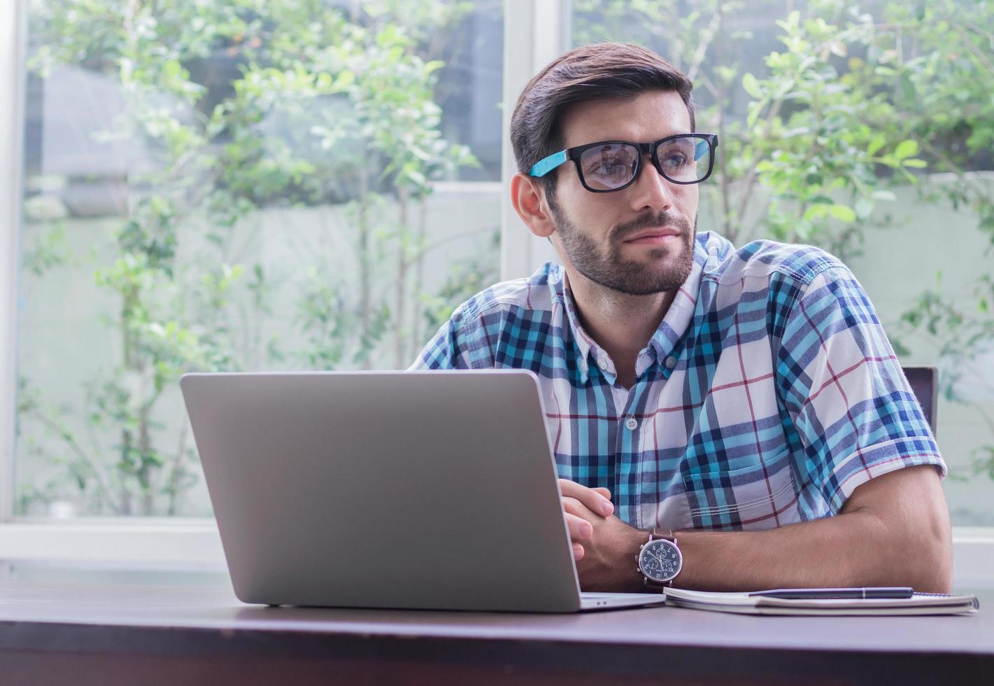 Businessman is working with a laptop. Concept of working and doing business online photo