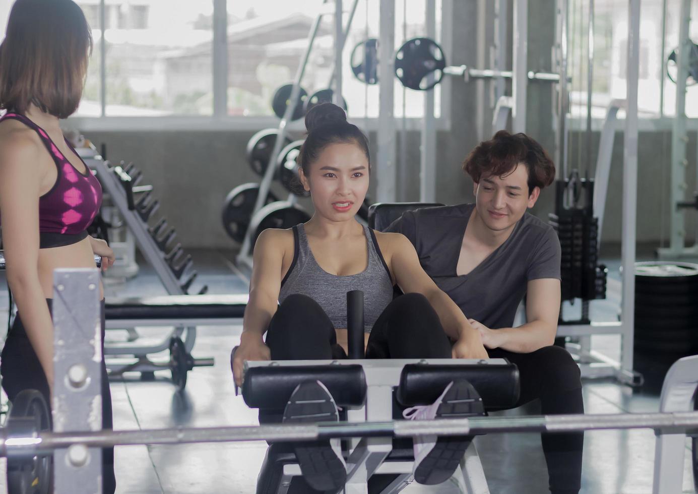 Young Asian couples are exercising in the gym. Concept of exercise for good health of the new generation. photo