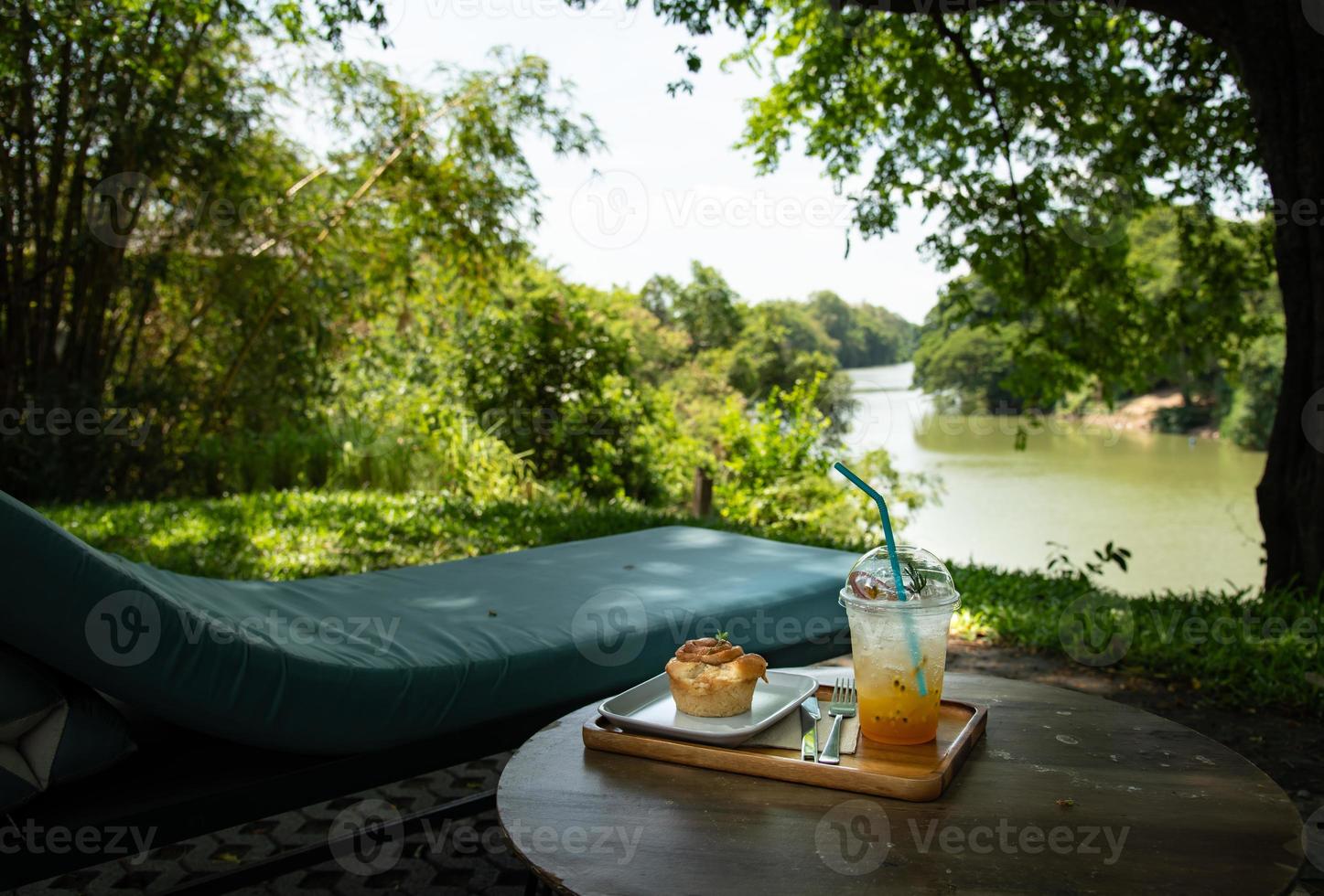 The garden behind the house has rivers flowing through with a relaxing corner in the green garden photo